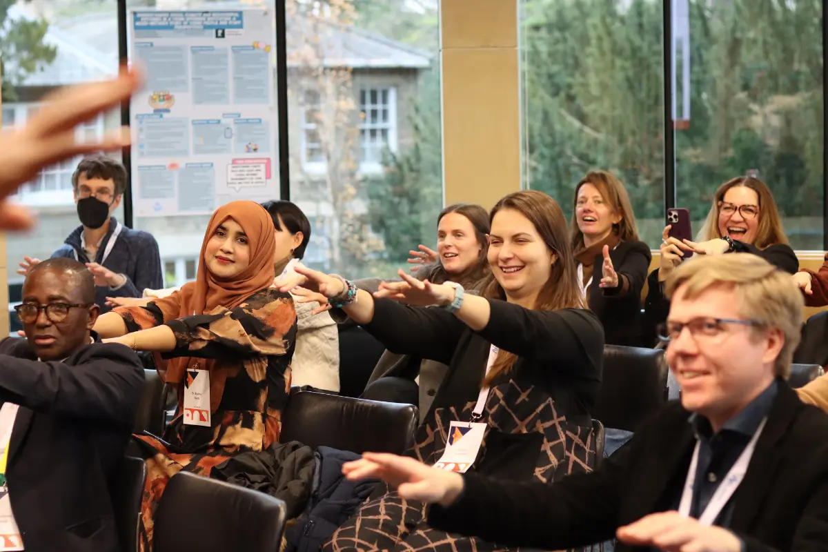 A lively, diverse audience taking part in a session at a past Acavent conference